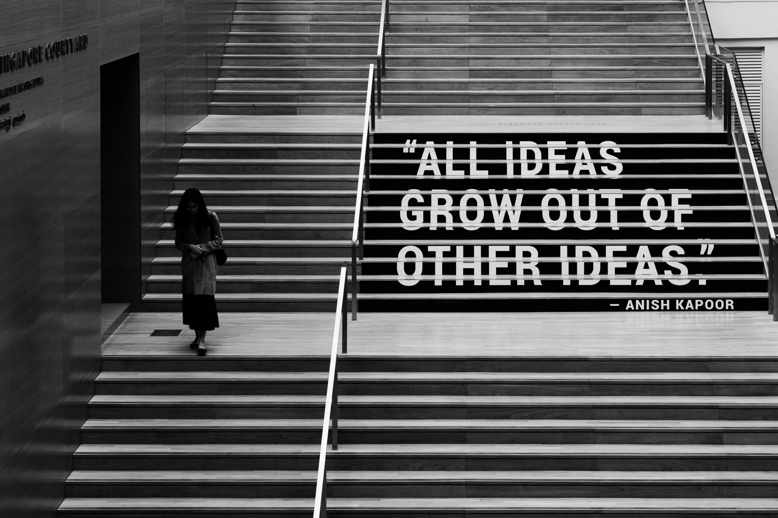 “Black and white photo showing the quote ‘All ideas grow out of other ideas’ representing creativity and innovation.”